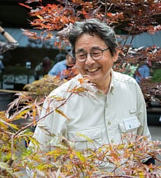 Sadafumi (Sada) Uchiyama portrait in midst maple tree.