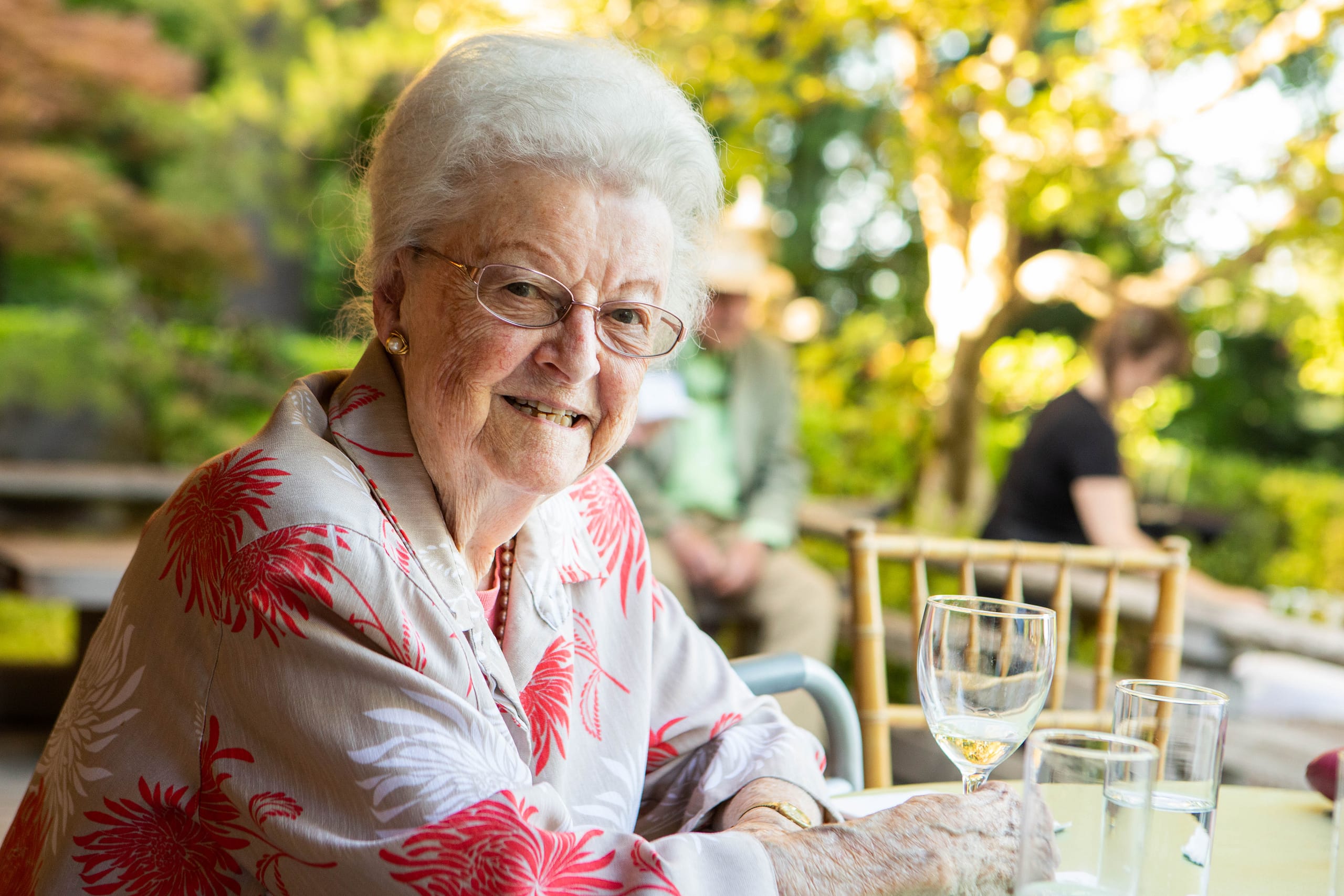 Maggie Drake sitting at a table, smiling.