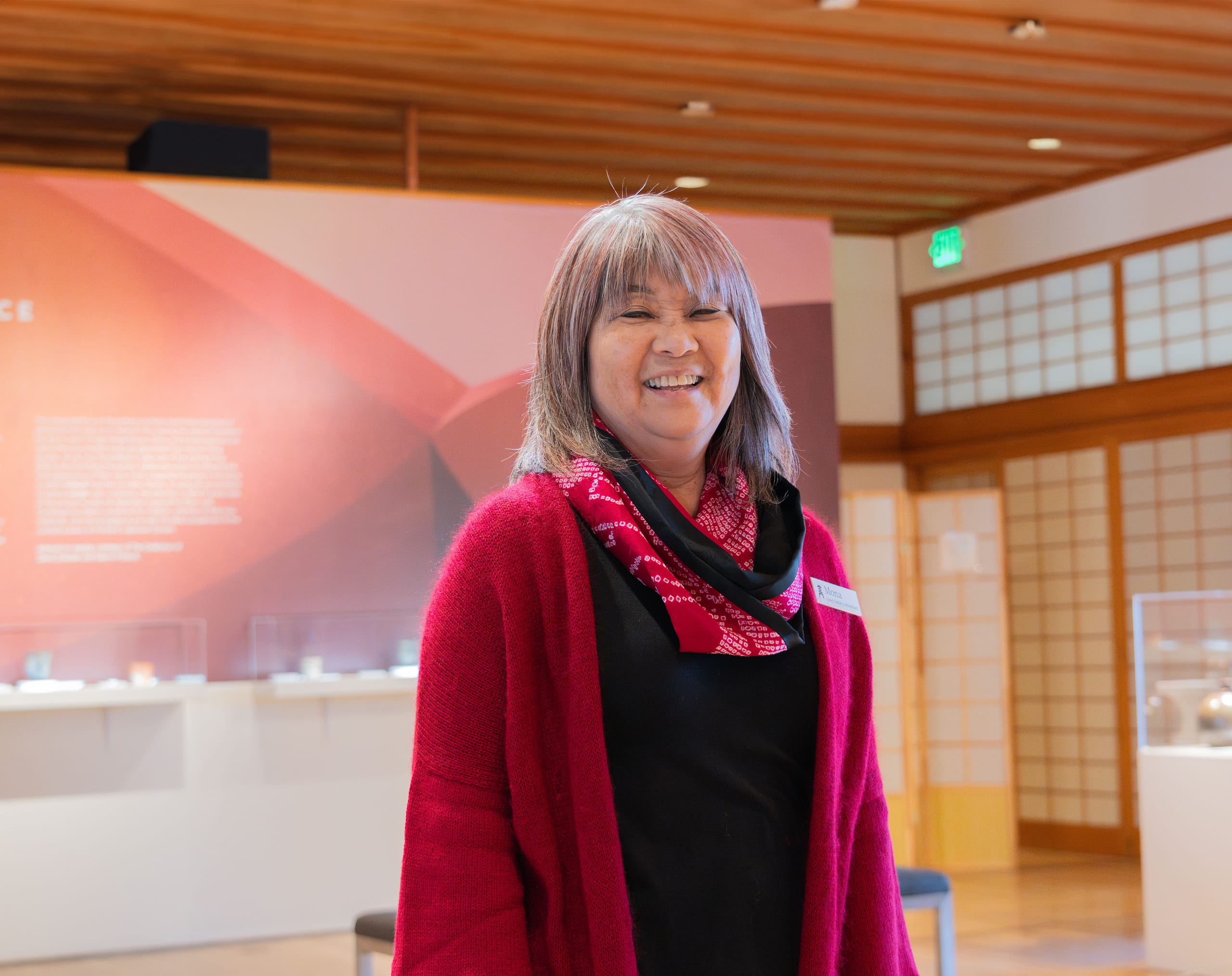 A woman stands in an art gallery.