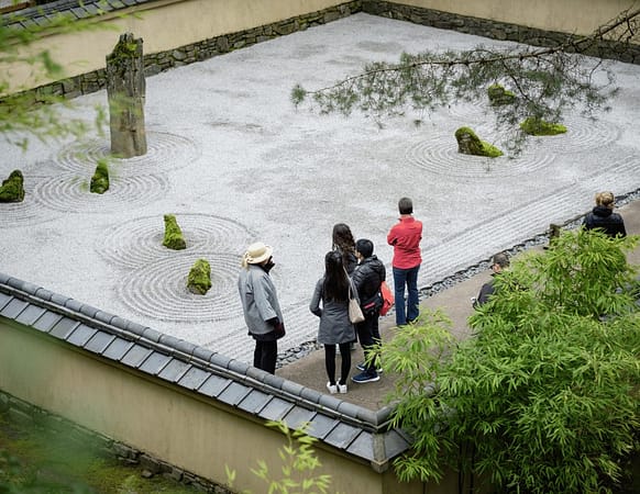 A group of Portland Japanese Garden members touring the Stone Garden.