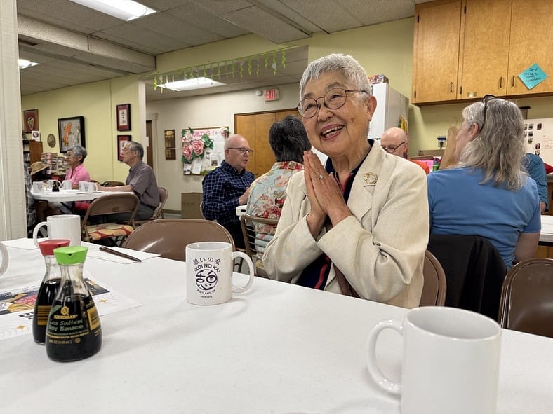 a woman clapping her hands with a large smile