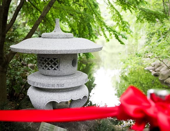 stone peace lantern behind red rope