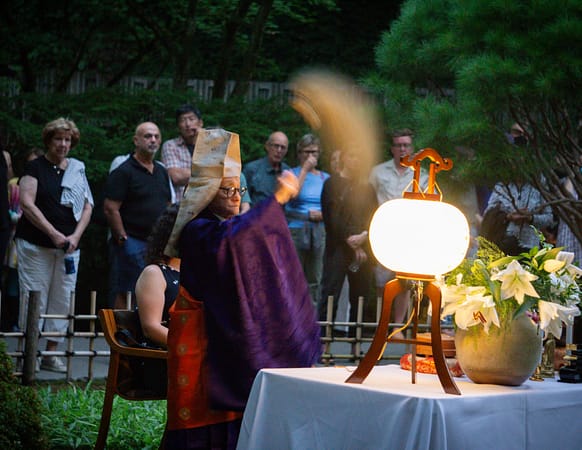 A Buddhist reverend performs a ceremony in Portland Japanese Garden.