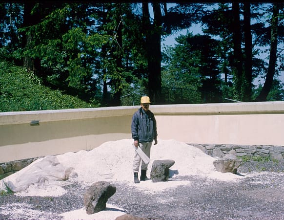 Professor Takuma Tono standing in the Sand and Stone Garden of Portland Japanese Garden during its construction.