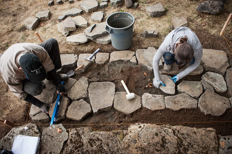 Learners applying their lessons to the placement of stones.