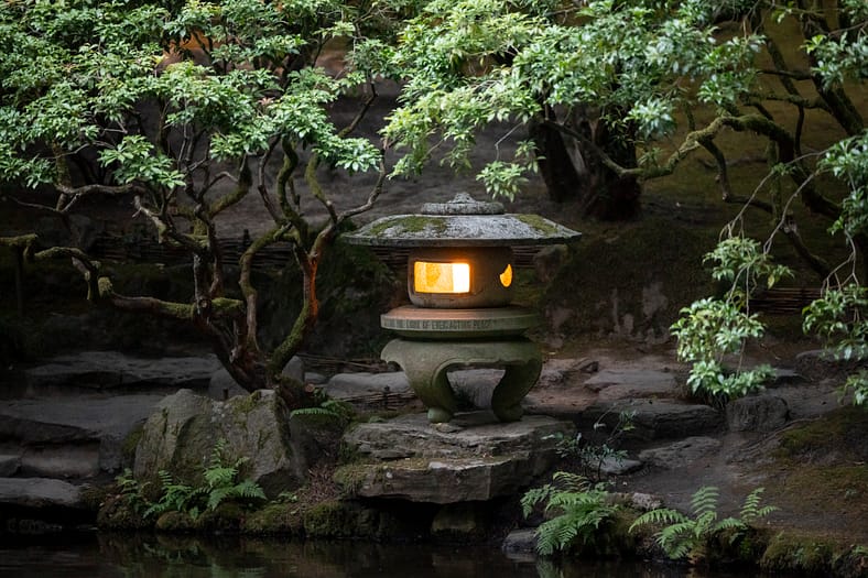 A stone lantern with a candle lit inside.