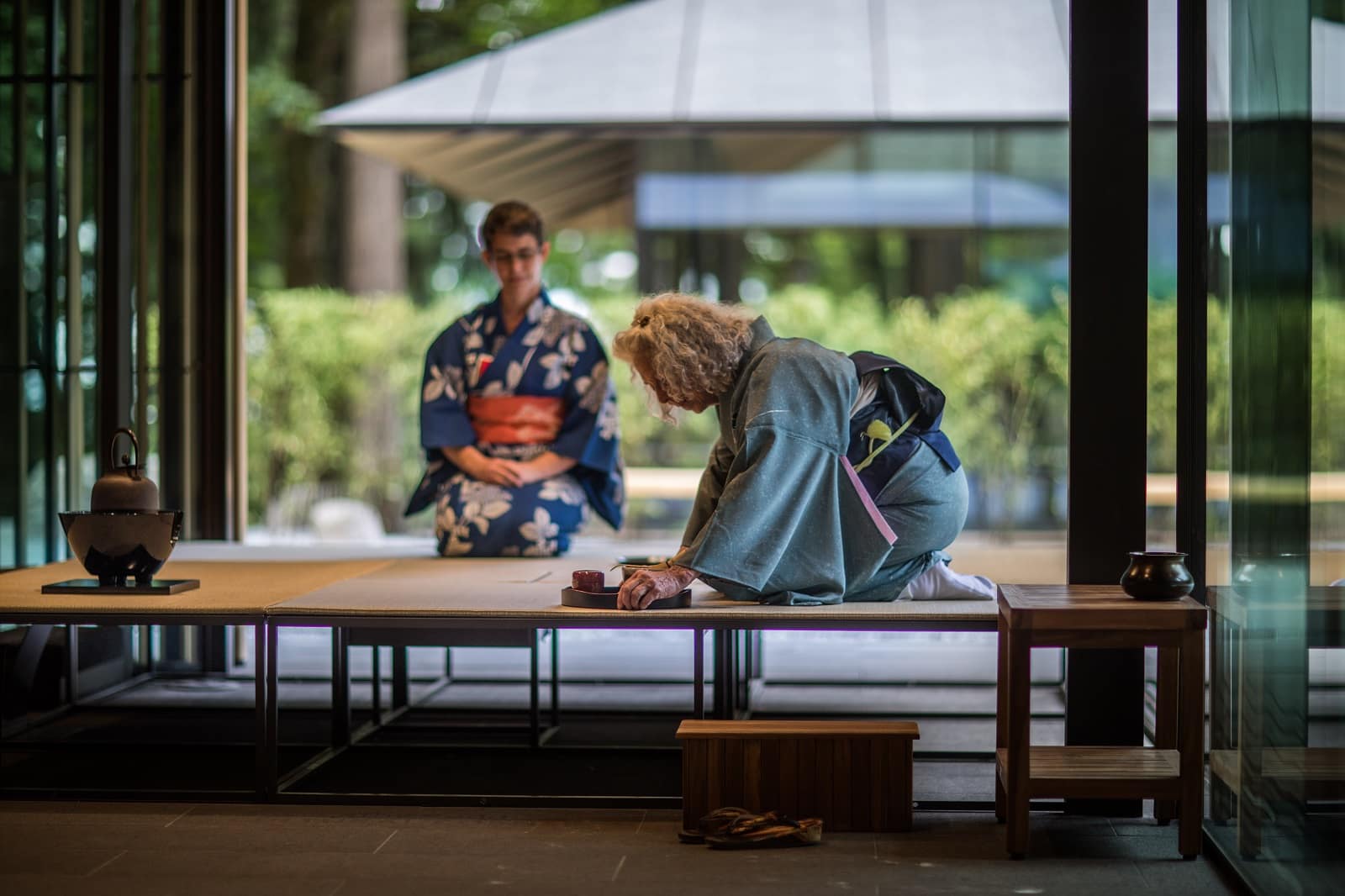 two women on tatami mats performing tea ceremony