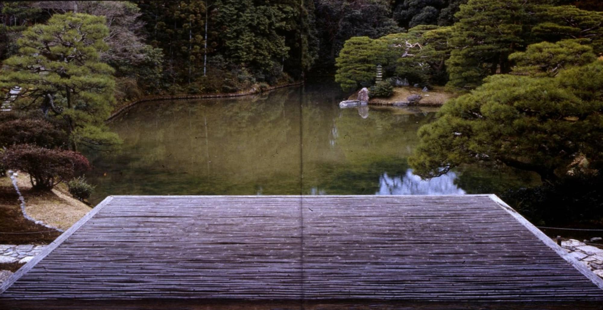 a simple wooden platform extended out toward a body of water