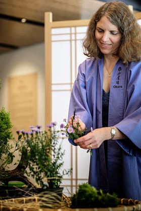 Carolyn Alter performing ikebana demo in the Cultural Corner