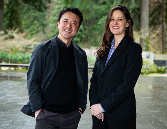 two individuals smiling for the camera