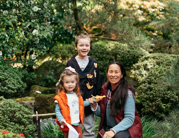 A mom and two children smile for the camera.