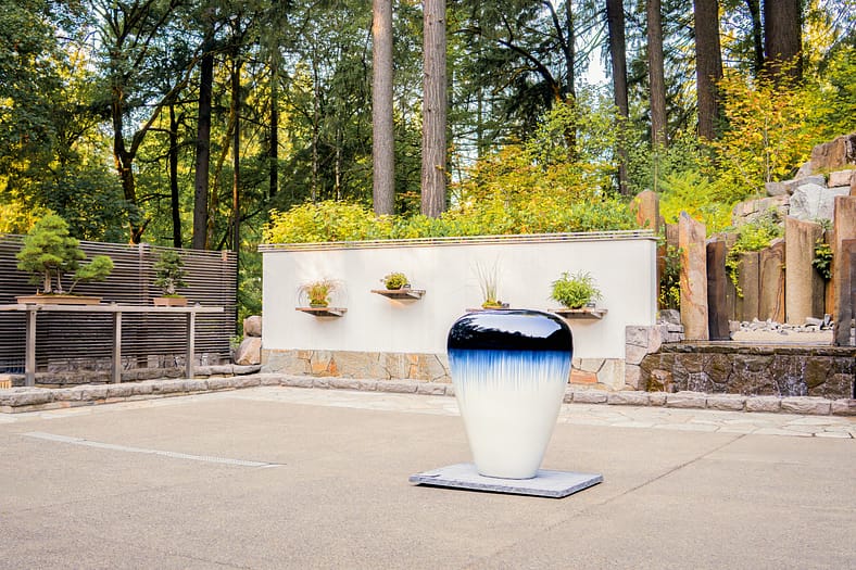 a terrace with a small sculpture and water feature