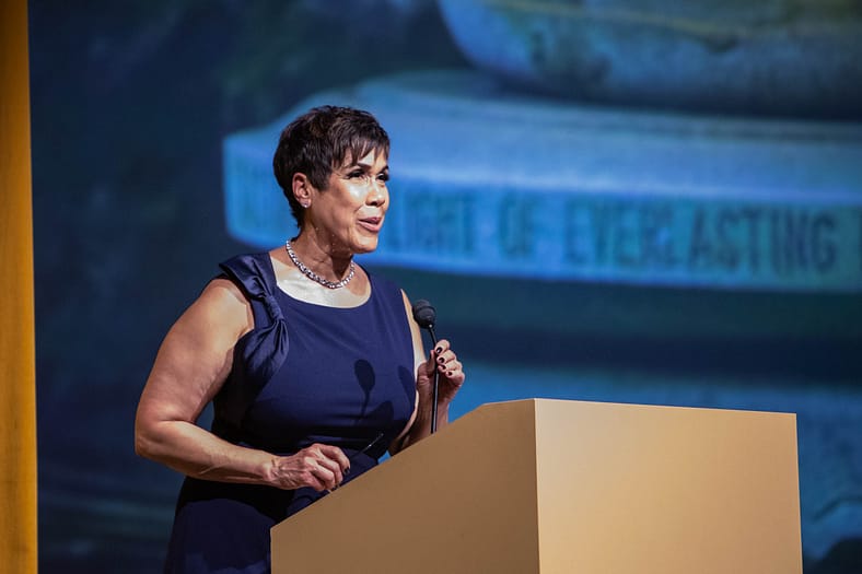 KGW-TV anchor Brenda Braxton standing at a podium during Portland Japanese Garden's 60th anniversary gala at Portland Art Museum.