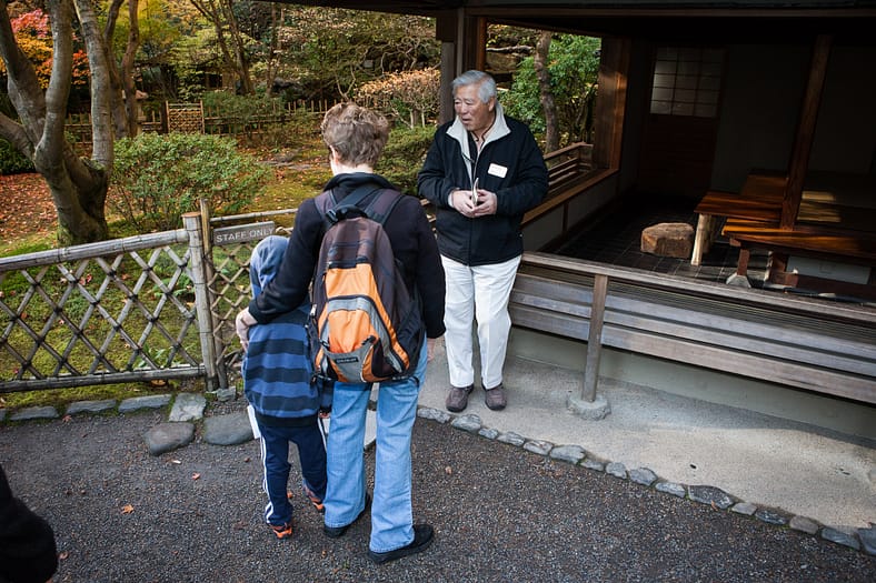 a man talking to tourists