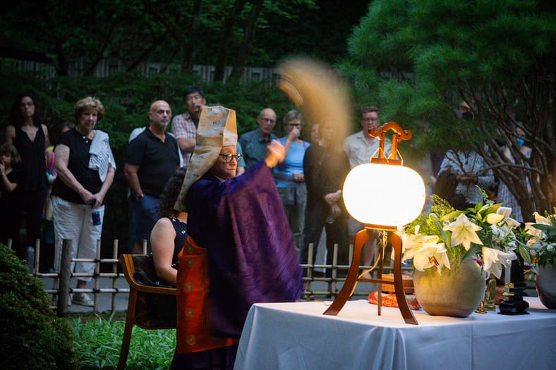 A Buddhist reverend performs a ceremony in Portland Japanese Garden.