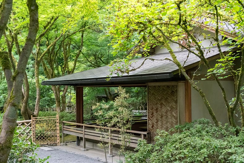 the exterior of a tea house with large viewing windows