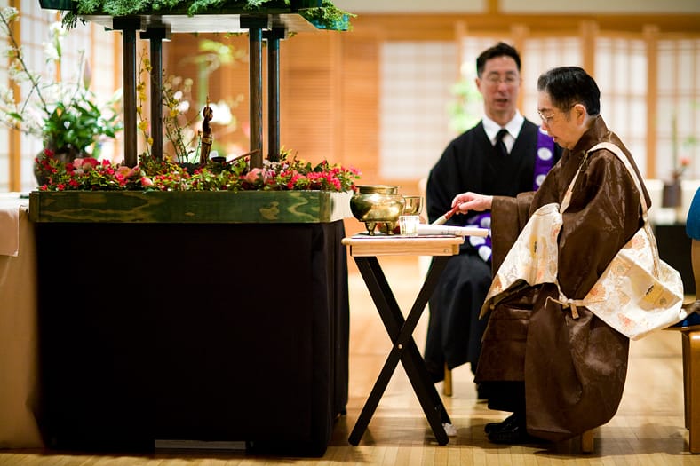 Two religious leaders sitting at a table.