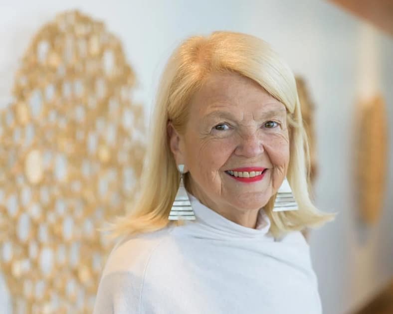 a woman smiling in a posed portrait