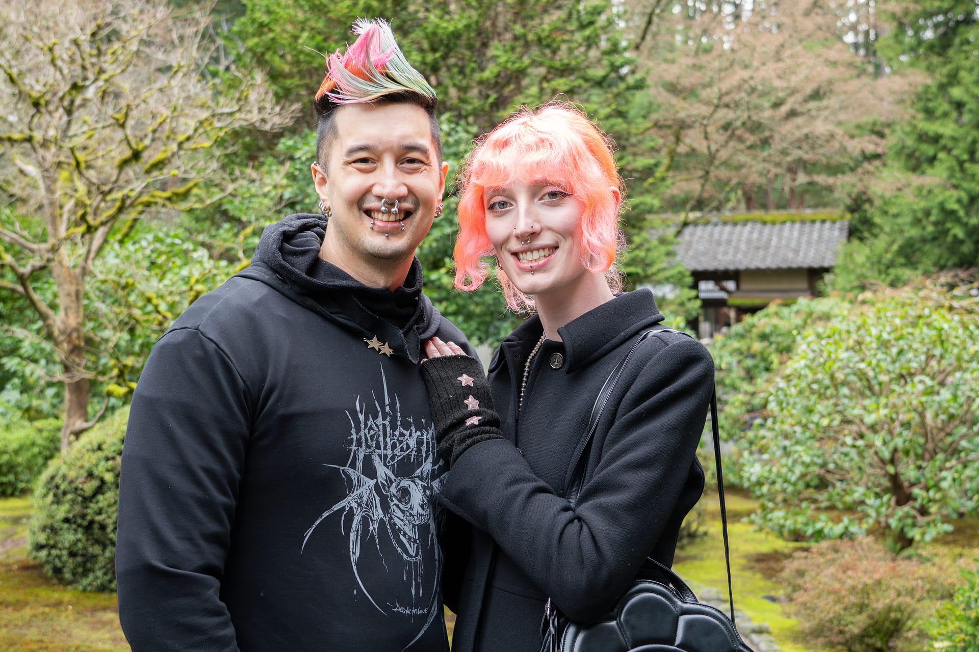 A couple smiles and poses for the camera.