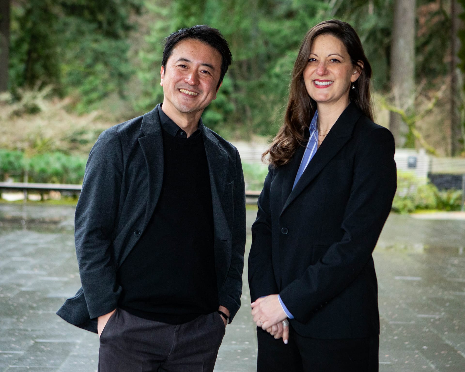 two individuals smiling for the camera