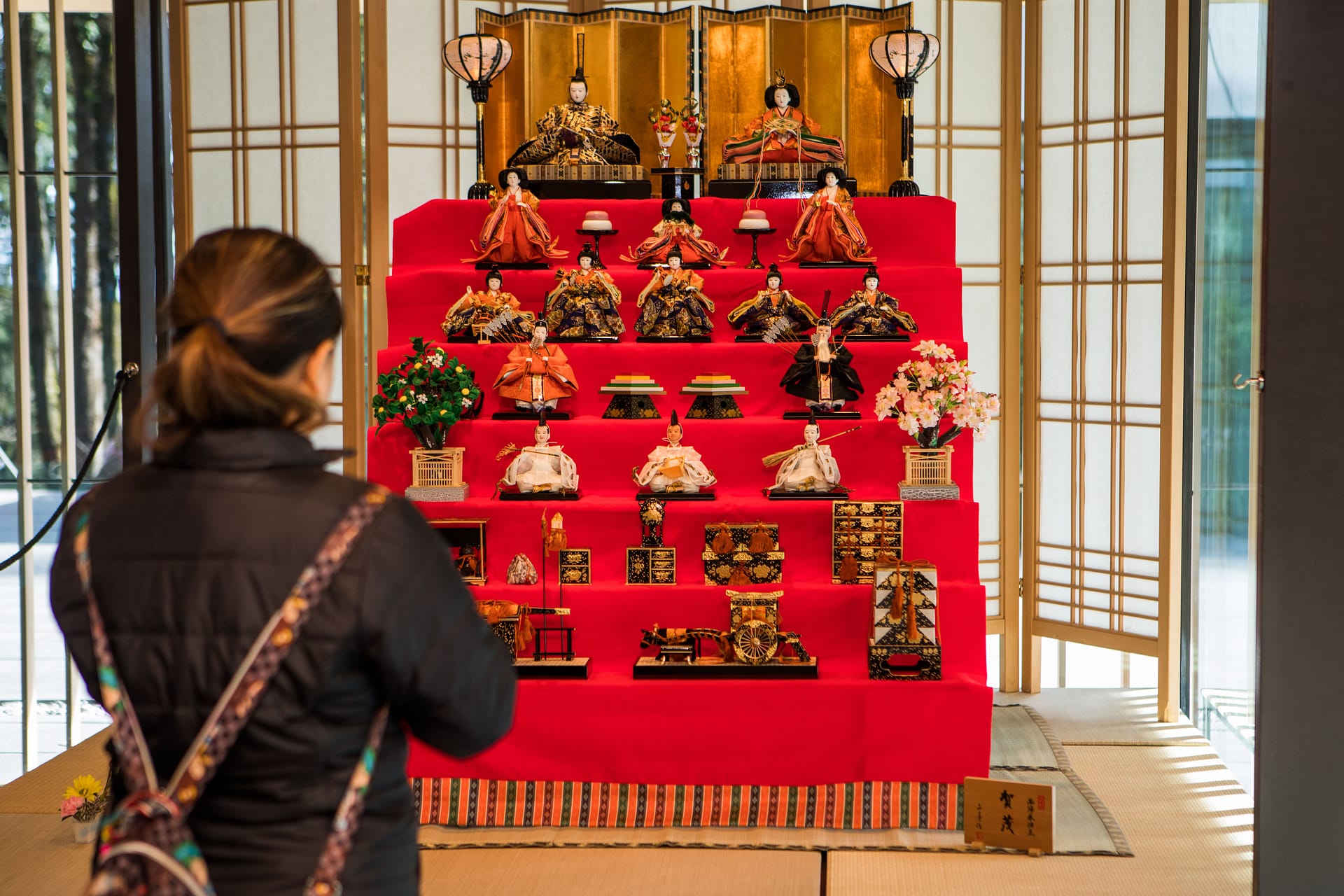 Woman taking photo of the Hina Matsuri display.