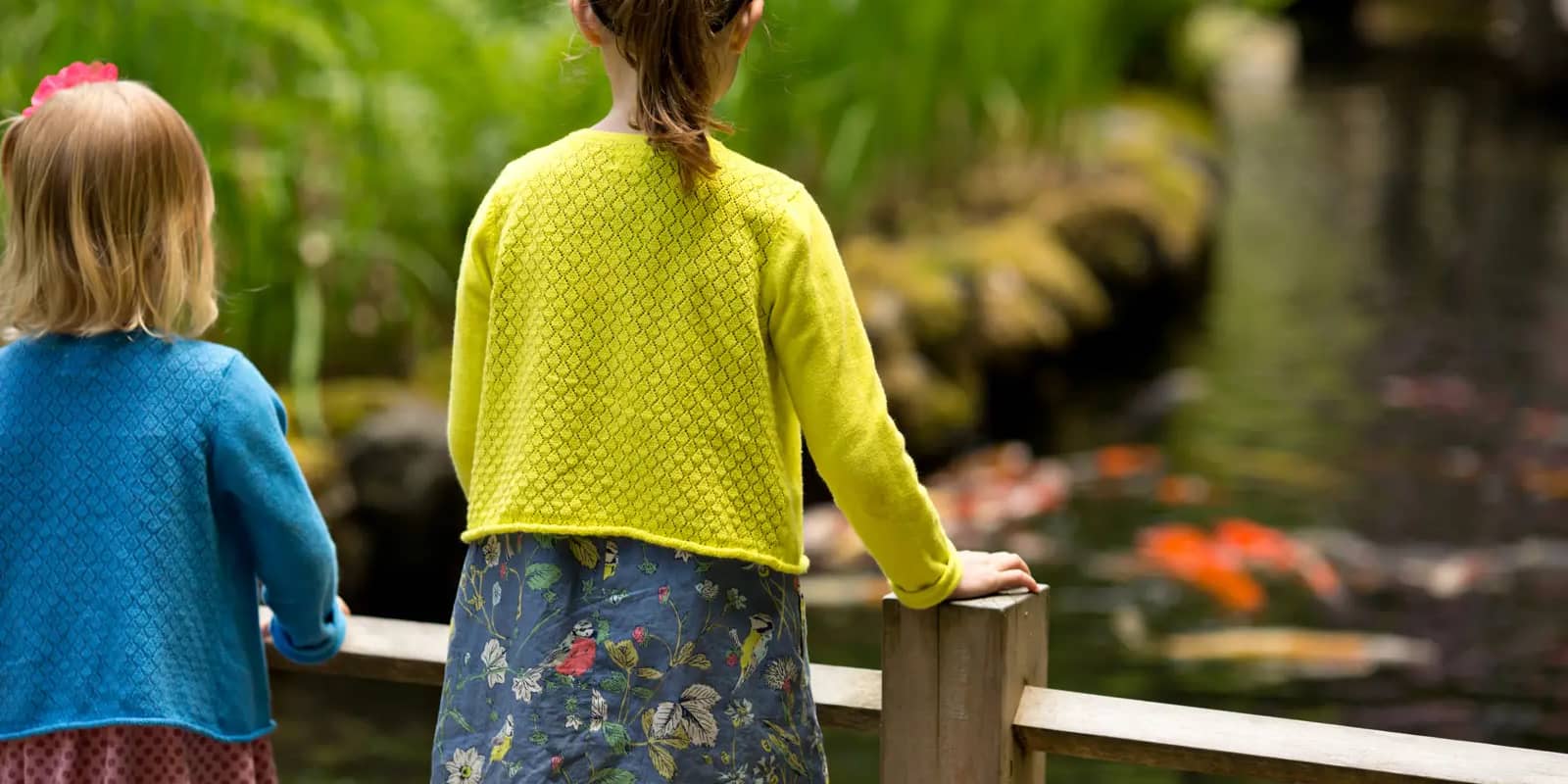 Sisters view the Koi on Children's Day. Photo by Scott Ryan