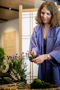 Carolyn Alter performing ikebana demo in the Cultural Corner