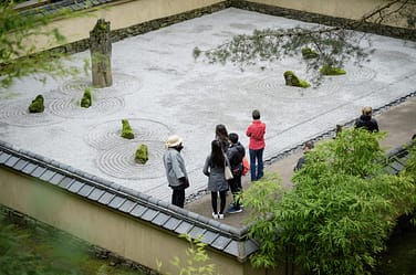 A group of Portland Japanese Garden members touring the Stone Garden.