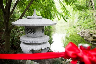 stone peace lantern behind red rope