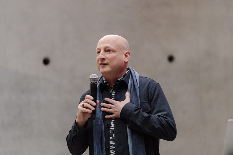 Steve Bloom speaking into a microphone.