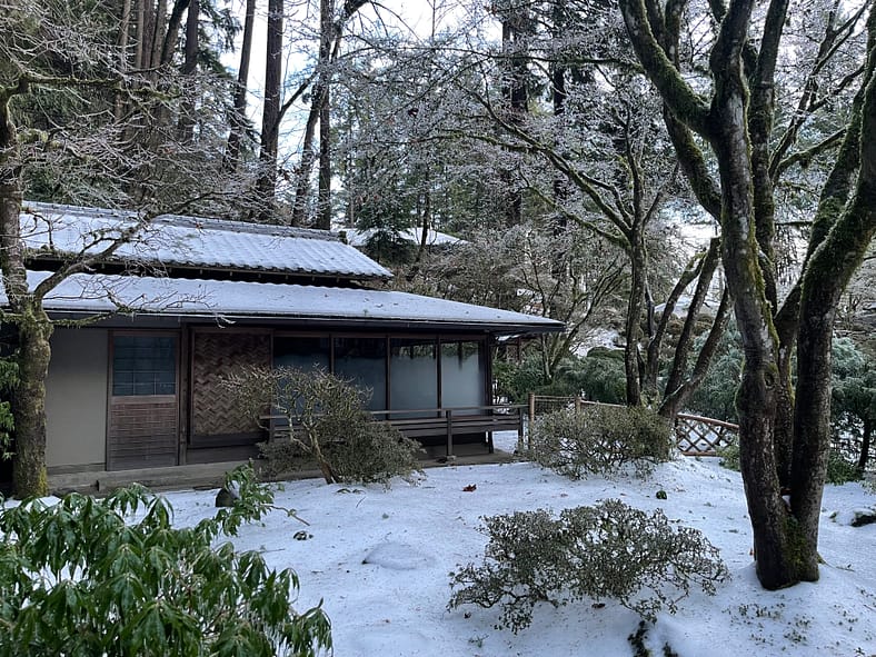 Snow and ice on a tea house and tea garden at Portland Japanese Garden