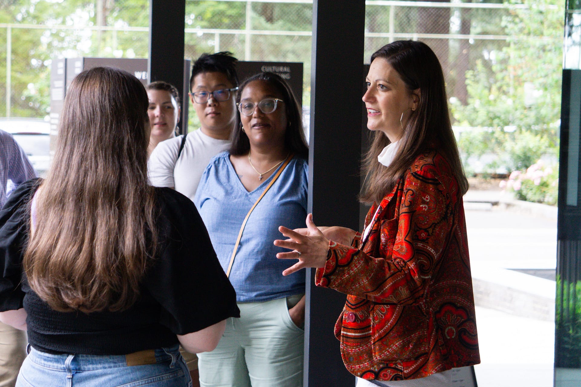 Lisa Christy talks to a group of people next to Portland Japanese Garden's Welcome Center before they head off on a tour of the Garden.