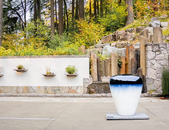 a terrace with a small sculpture and water feature