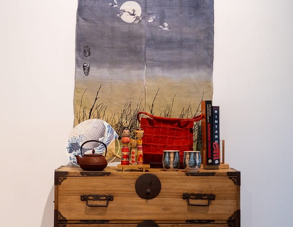 a piece of furniture with items for sale on it