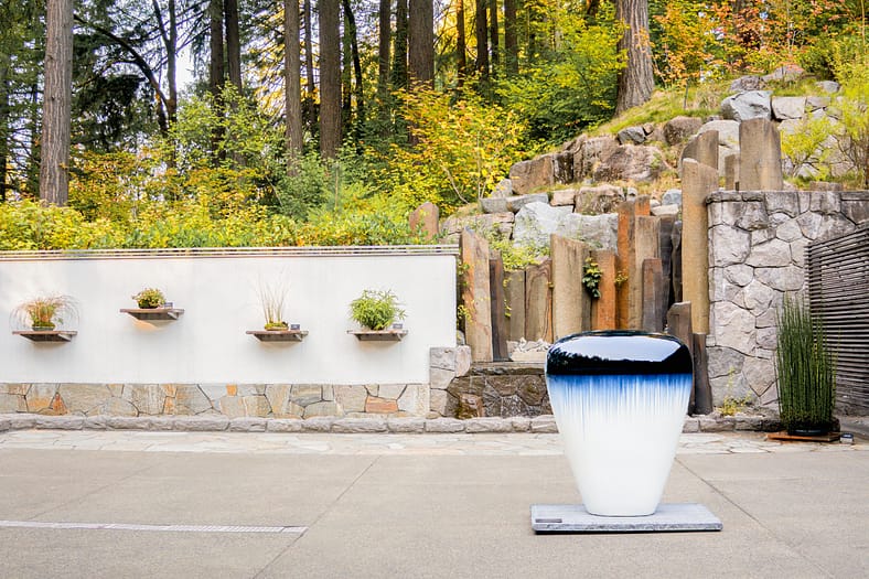 a terrace with a small sculpture and water feature