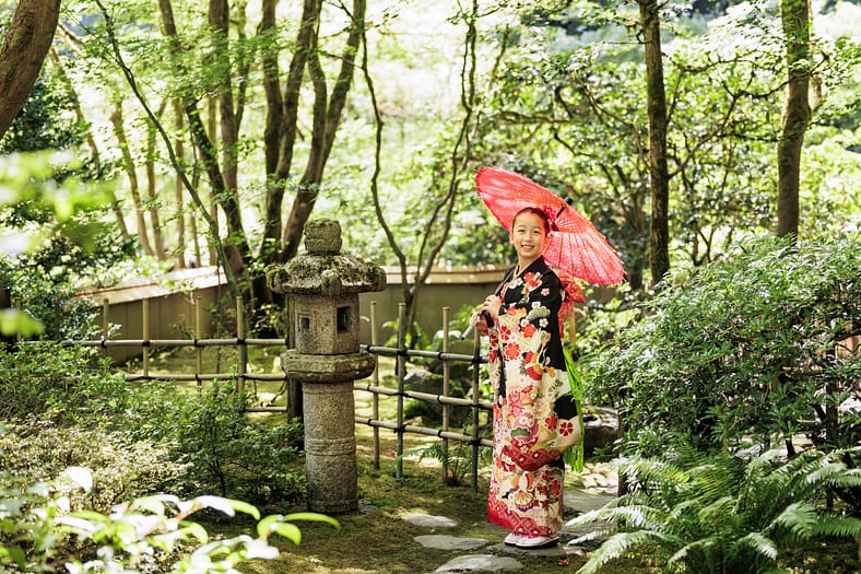 A girl in Kimono posing in the tea garden for Shichi Go San