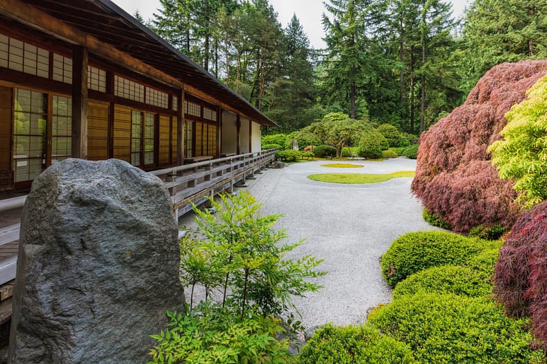 Portland Japanese Garden's flat garden with raked gravel and a Pavilion next to it.