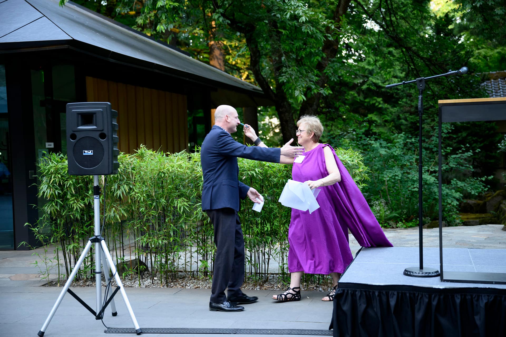 Steve Bloom walking over to Caryl Stern with outstretched arms.