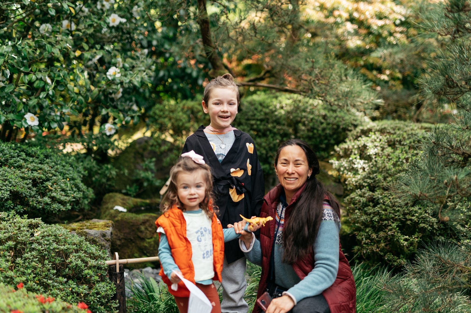 A mom and two children smile for the camera.