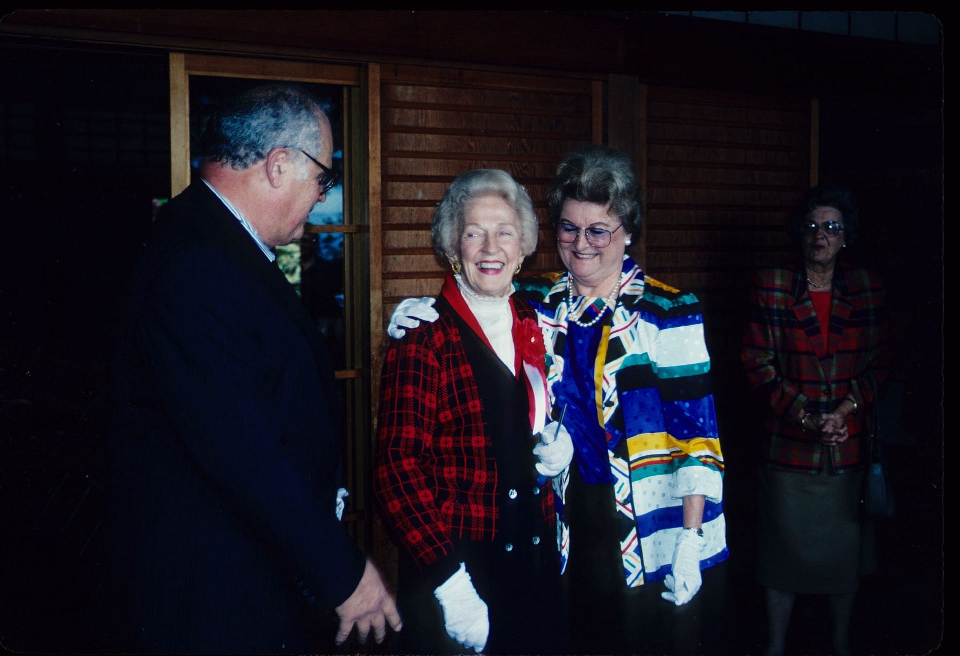 Three people standing posing for a photo at a party at Portland Japanese Garden.