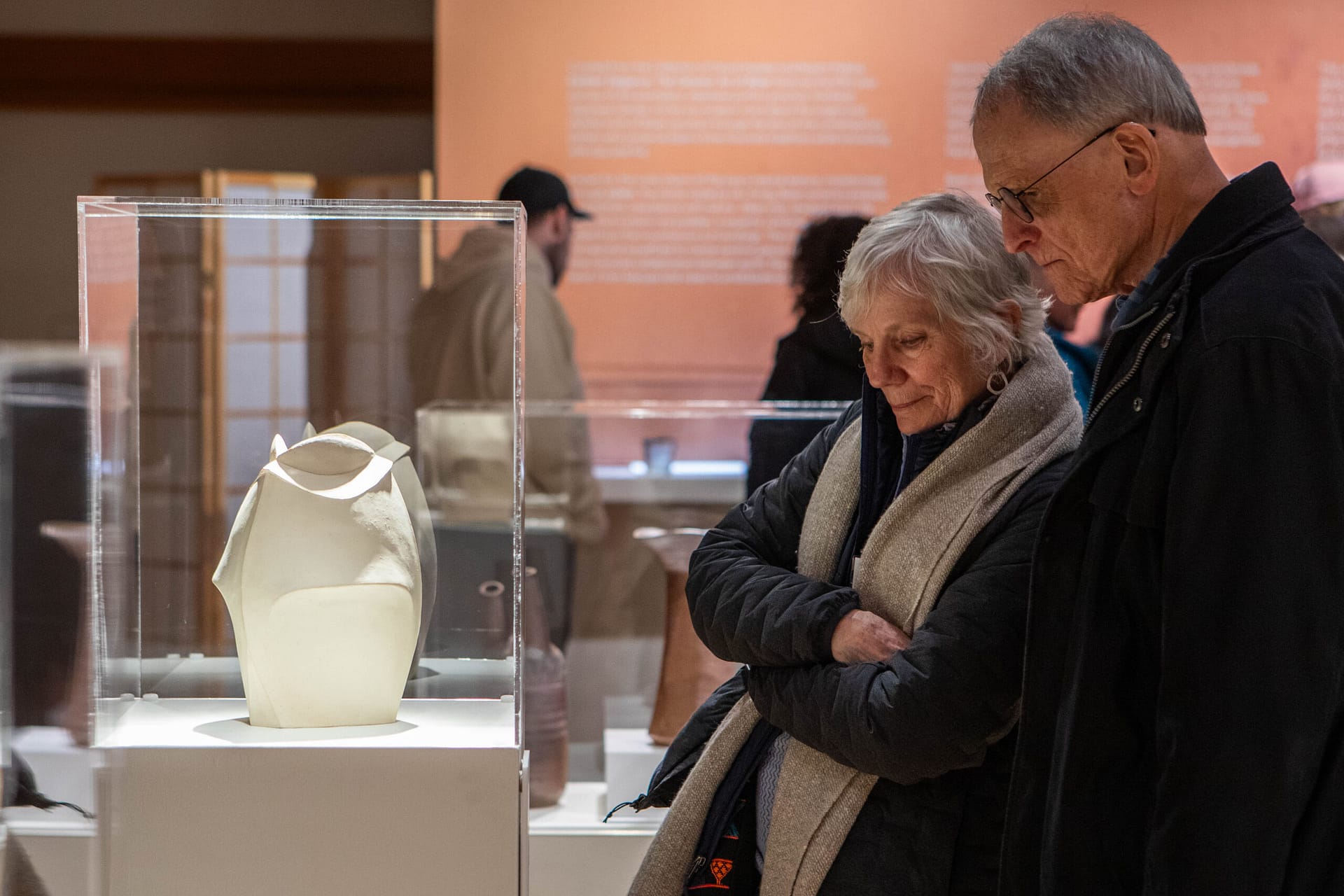 A couple looks at ceramic art.