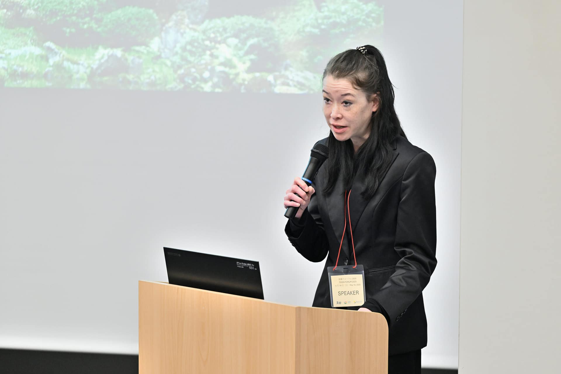 a woman speaking into a microphone