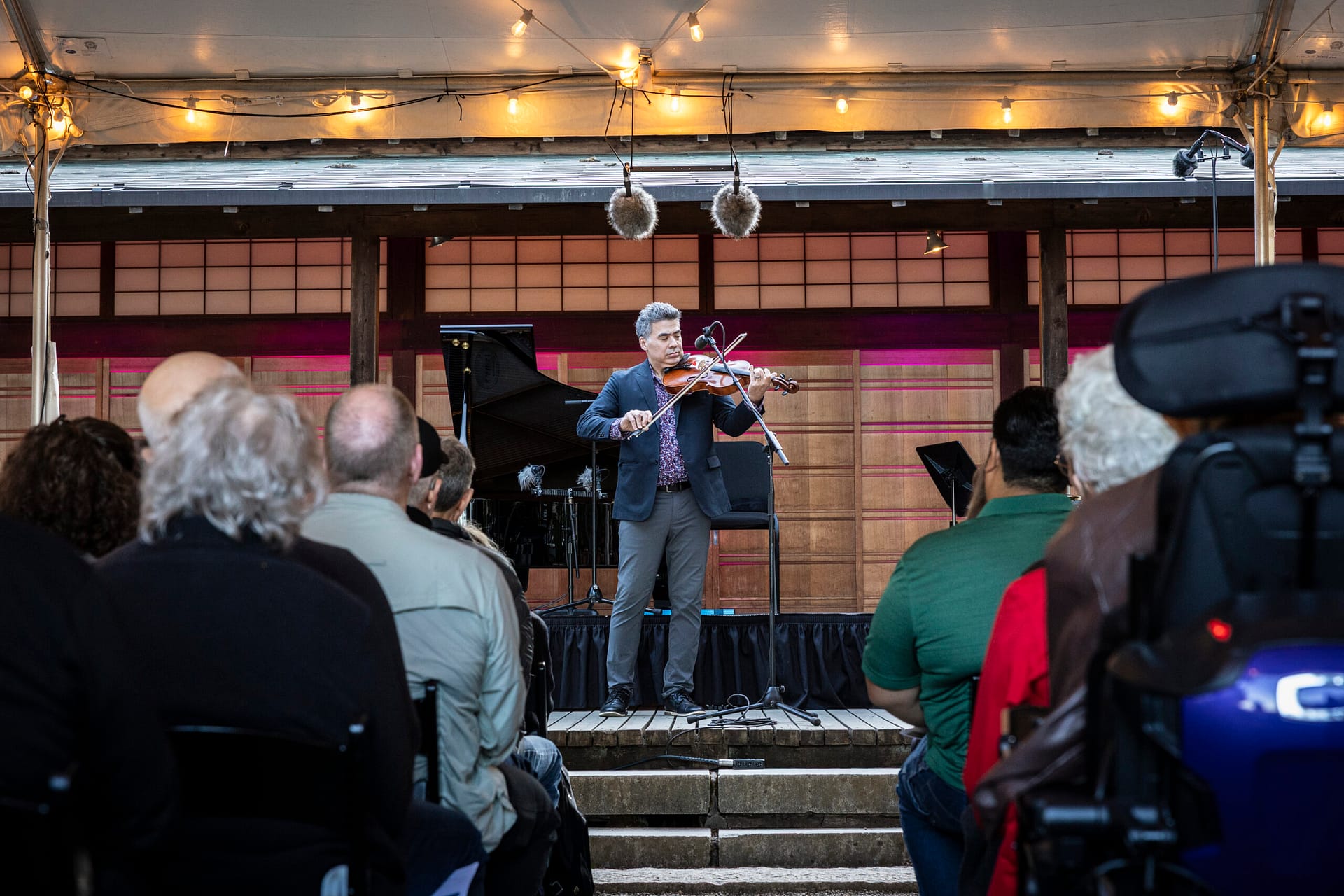 a violinist performs on a stage in front of an audience